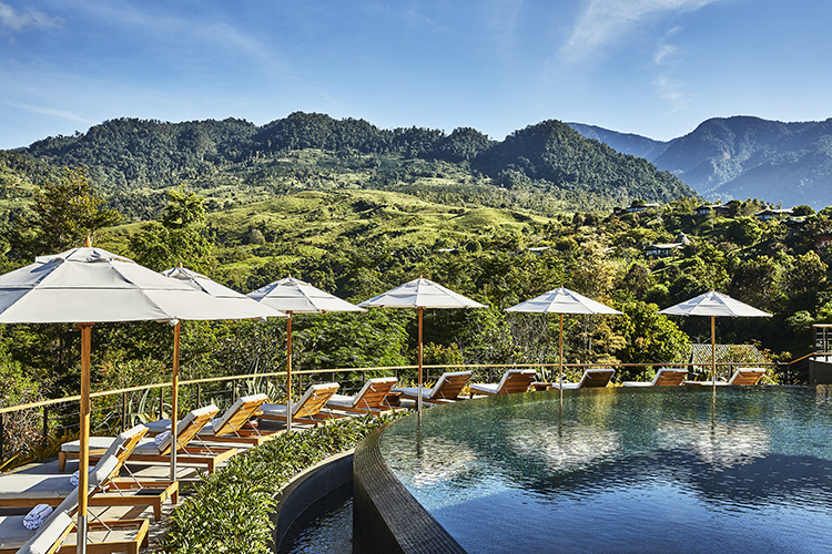 pool and lounge chairs with beautiful mountain views