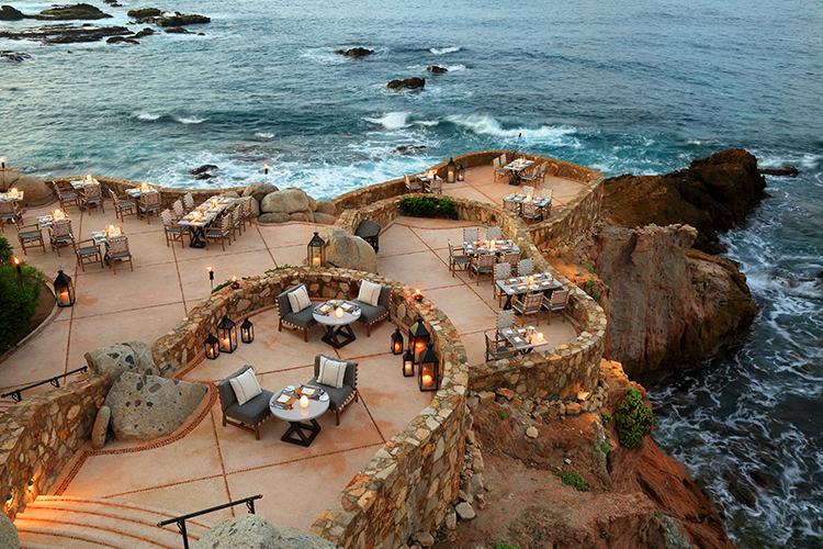 outdoor restaurant tables near the ocean cliff