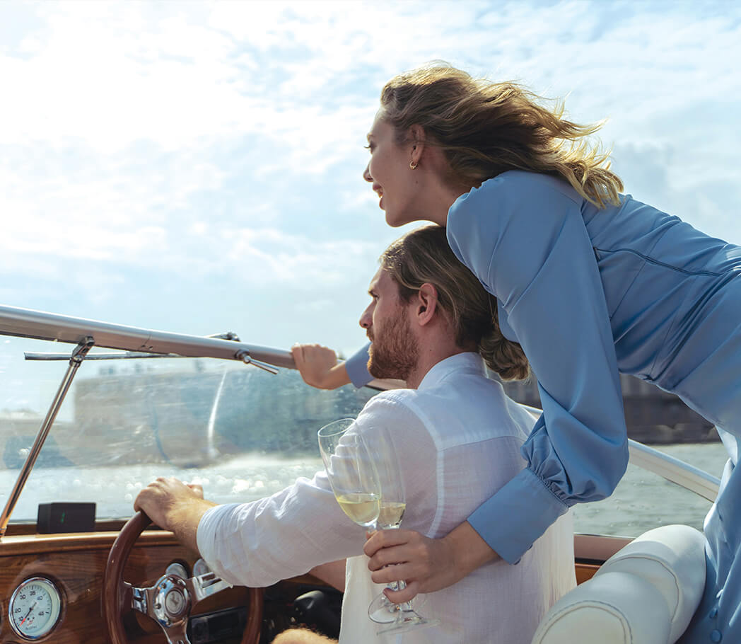 Couple on a boat with glasses of champagne